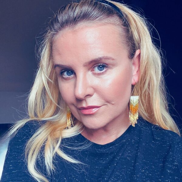 A woman with blonde hair and blue eyes.